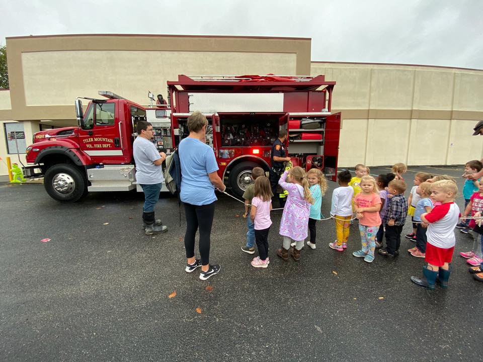 Children listening to a firefighter | Cross Lanes Child Care and Learning Center in Charleston, WV